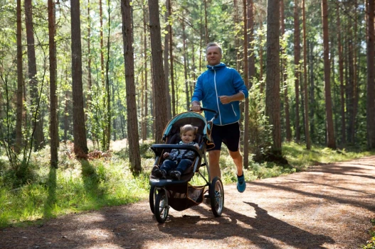 Dad running baby carriage